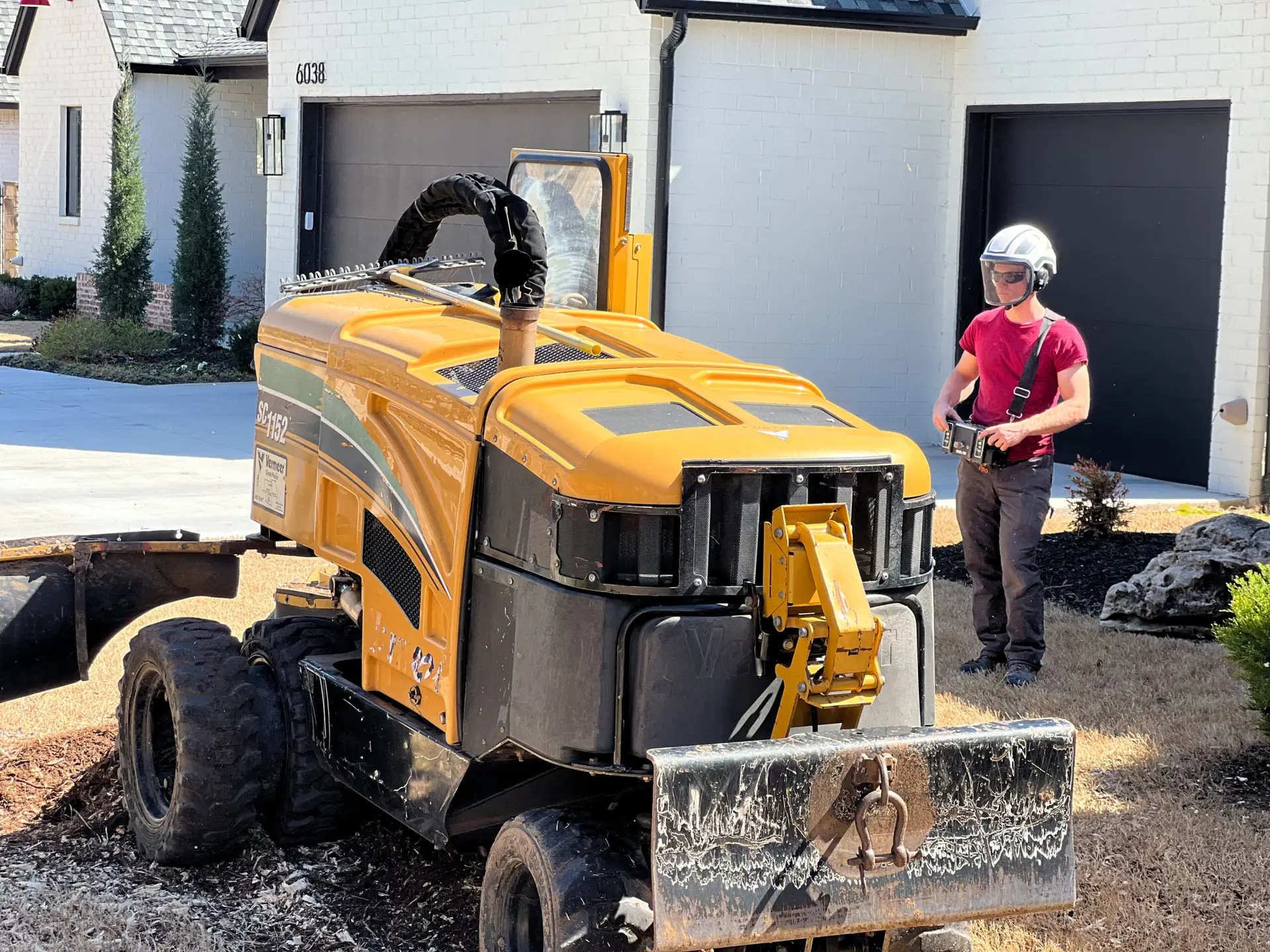 An image of a Paragon Tree Care crew member driving a piece of tree removal equipment